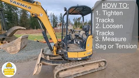 how to get the track back on a mini excavator|mini excavator track release.